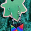 Rectangular clay drops of a rainbow tie-dye with black upper inner corners, hanging from clear and black glass stations from silver earwires