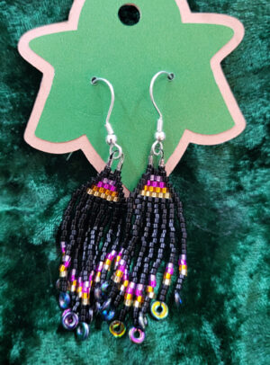 BrickStitchBlackSunrise Woven bead triangle earrings with long bead fringe, mostly black with a purple-pink-orange-yellow gradient.