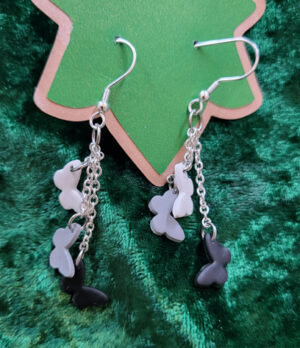 ButterfliesBlack Earrings dangling white, grey and black butterflies from silver chain at various levels.